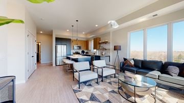 New Brighton apartment for rent - a living room and kitchen with a couch and a table