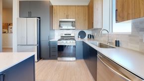 New Brighton apartment for rent - a kitchen with a stove top oven next to a sink at The Exchange Apartments, Minnesota, 55112