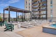 Minneapolis apartment for rent - an outdoor lounge area with lounge chairs and umbrellas at the melrose apartments at The Gateway at West Lake Quarter in Minneapolis, MN