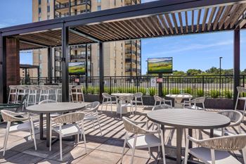 An outdoor patio with tables and chairs