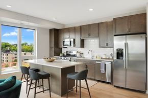 Minneapolis apartment for rent - a kitchen with a large island and stainless steel appliances at The Mezz at West Lake Quarter, Minneapolis, 55416