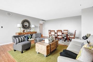 Minneapolis apartment for rent - a living room with a couch and chairs and a dining room table