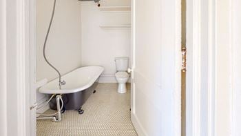 A bathroom with a bathtub and a toilet