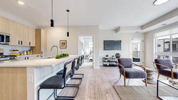 Long Lake apartment for rent - an open kitchen and living room with a large island and chairs