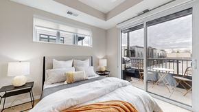 Long Lake apartment for rent - a bedroom with a bed and a sliding glass door to a balcony