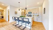 Long Lake apartment for rent - a kitchen with a island and three chairs