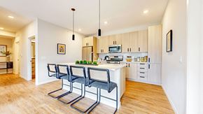 Long Lake apartment for rent - a kitchen with a island and three chairs