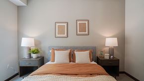 South St. Paul apartment for rent - a bedroom with a bed and two lamps and pictures on the wall