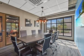 A conference room with a large table and chairs