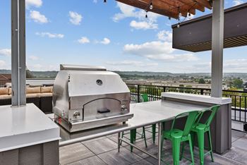 An outdoor kitchen with a grill