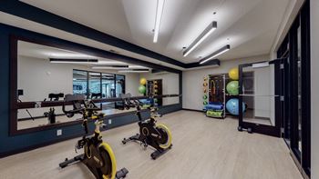 A gym with exercise equipment and weights