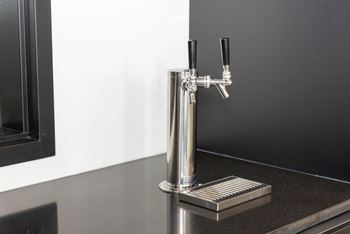 A close up of a kitchen tap on a counter top