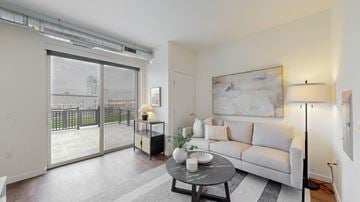 Minneapolis apartment for rent - A living room with a grey couch, a coffee table, and a painting on the wall.