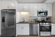 Minneapolis apartment for rent - a kitchen with stainless steel appliances and white cabinets at The Gateway at West Lake Quarter, Minneapolis, MN, 55416