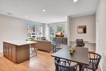 A kitchen and living room with a table and chairs