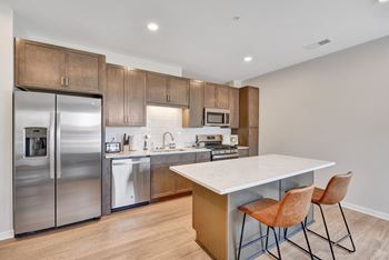 A kitchen with wooden cabinets and stainless steel appliances