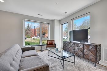 A living room with a large window and a couch