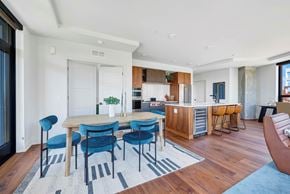 Minneapolis apartment for rent - a dining area with a table and chairs and a kitchen in the background