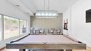 Minnetonka apartment for rent - A pool table in a room with a patterned wallpaper.