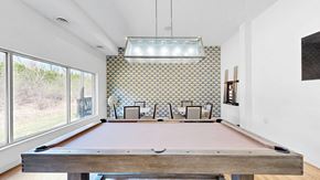 Minnetonka apartment for rent - A pool table in a room with a patterned wallpaper.