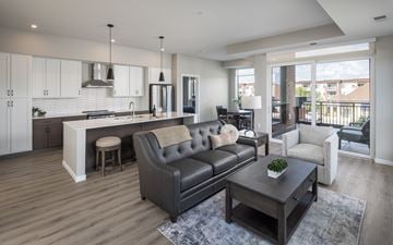 Waconia apartment for rent - A modern living room with a grey sofa and a wooden coffee table.