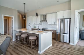 Waconia apartment for rent - A kitchen with a white counter and stools.