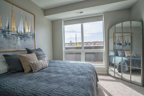 Waconia apartment for rent - A bedroom with a large bed and a painting on the wall.