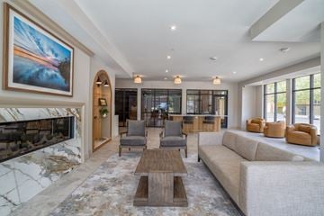 Waconia apartment for rent - A living room with a fireplace and a large painting on the wall.