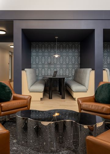 Oakdale apartment for rent - A modern living room with a glass table and brown leather chairs.