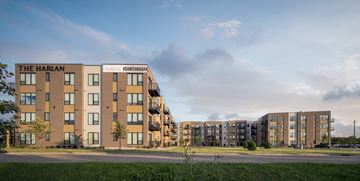 Oakdale apartment for rent - The Harlan apartment complex is a multi-story building with a modern design.