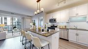 Minnetonka apartment for rent - A modern kitchen with white cabinets and a large island.