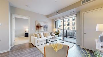 Minnetonka apartment for rent - A living room with a white couch and a painting on the wall.