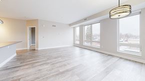Saint Paul apartment for rent - A spacious room with wooden flooring and a large window.