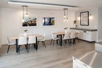 Cozy clubroom with indoor fireplace, coffee bar, and workspace.
