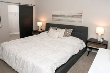 Alcove-type bedroom with rolling barn door and transom window for natural light
