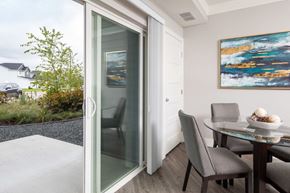 Lakeville apartment for rent - A modern dining room with a glass table and chairs.at The Edison at Avonlea, Minnesota, 55044