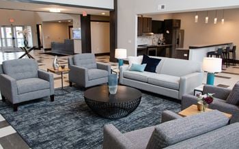 A living room with grey couches and a coffee table.
