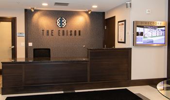 Lobby with a wooden reception desk.