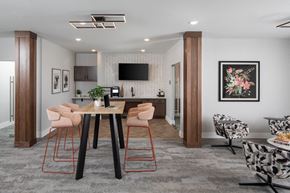 Maple Grove apartment for rent - A modern dining room with a wooden table and chairs.at The Edison at Maple Grove, Maple Grove