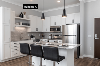 A modern kitchen with white cabinets and a center island.