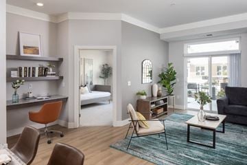 Shoreview apartment for rent - A living room with a brown leather chair and a grey couch.