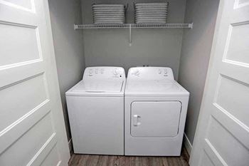 A white washer and dryer in a small laundry room.