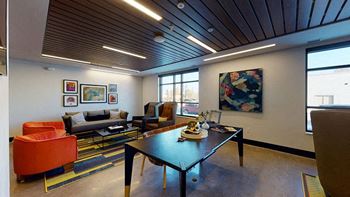 A modern living room with a wooden ceiling and a large painting on the wall.