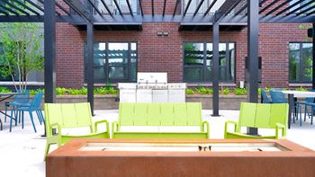 A green bench is in the middle of a courtyard.