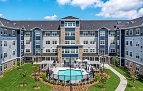 White Bear Lake apartment for rent - A large apartment complex with a pool in the middle of the courtyard at The Barnum Apartments, Minnesota