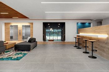A modern living room with a grey floor and a wooden ceiling.