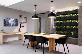 A modern dining room with a long table and chairs.