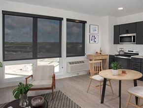 Minneapolis apartment for rent - A modern kitchen with a dining table and chairs at The Redwell Apartments, Minneapolis, MN 55401
