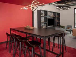 Minneapolis apartment for rent - A modern dining area with a dark table and chairs at The Redwell Apartments, Minneapolis, 55401