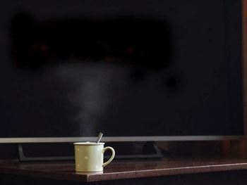 A cup of hot beverage with steam rising from it